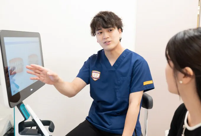 モニターで治療内容を説明する診療の様子